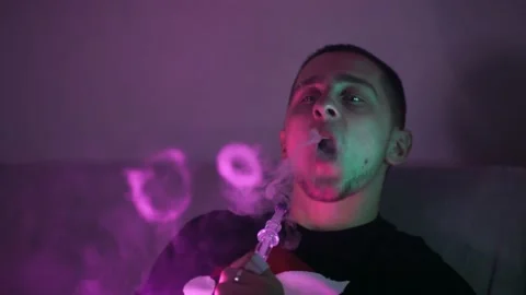 The guy smokes a hookah Video stock 145943834