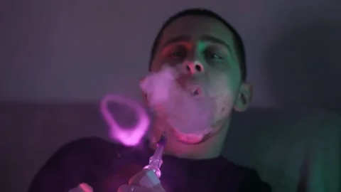 The guy smokes a hookah Stockbeeldmateriaal 145943836