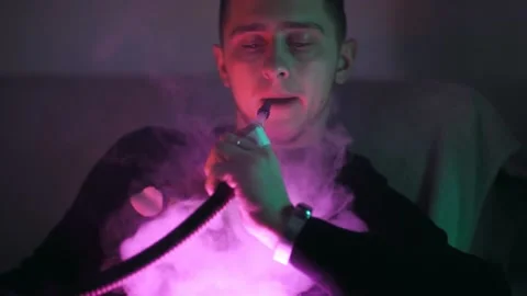 The guy smokes a hookah Stockbeeldmateriaal 145943843