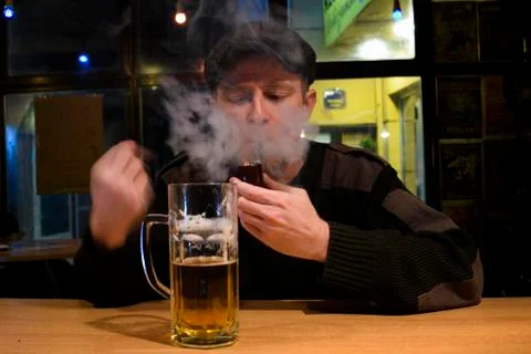 Guy smokes pipe in the bar Stock Photos