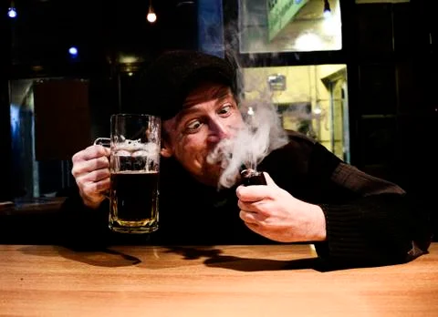 Guy smokes pipe in the bar Stock Photos