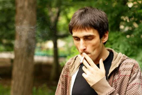 Guy is smoking a cigarette Stock Photos