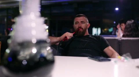 Guy smoking hookah Stock Footage 65259439