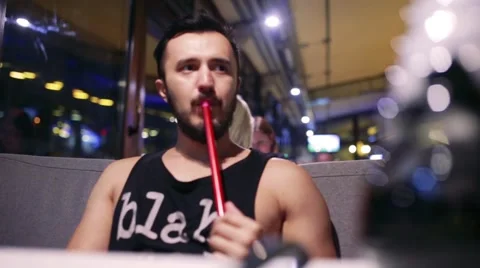 Guy smoking hookah Stock Footage 65259481
