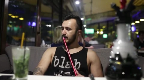 Guy smoking hookah Stock Footage 65259664