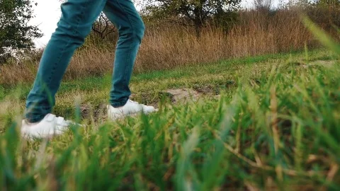 The guy in sneakers goes along the trail Stock Footage 80436039