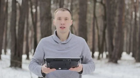 Guy in the snow-covered forest with laptop Stock Footage 85517288