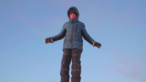 The guy is on a snow slope against the sky. Snowy winter landscape. Sports 動画素材 85025499