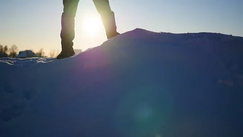 The guy is on a snow slope and raises his hands up at sunset.snow winter Vidéo 71885304