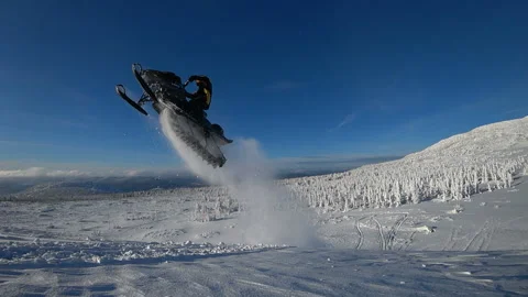Guy on a snowmobile jumping and flying high. slow motion Video stock 99631705