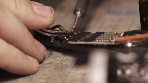 Guy soldering drone FPV wires with dirty fingernails Video stock 139544891
