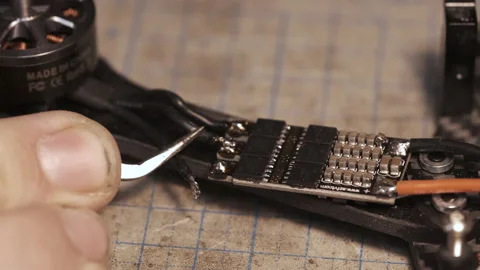 Guy soldering drone FPV wires with dirty fingernails Stock-Footage 139545799