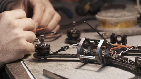 Guy soldering drone FPV wires. Frontframe view Stock Footage 139547880