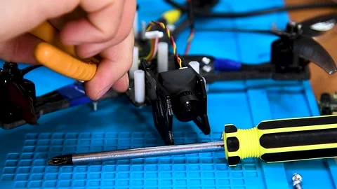 Guy soldering drone FPV wires Stock Footage 320996822