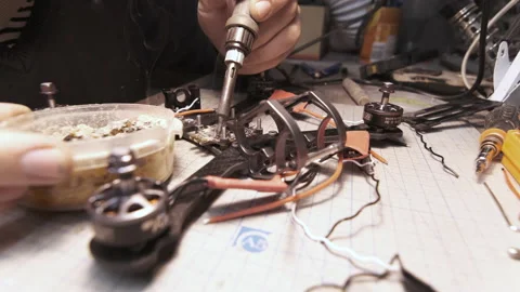 The guy solders the FPV chips of the drone. Front frame view Video stock 139550056
