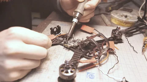 The guy solders the FPV chips of the drone. Front frame view Video stock 139550168