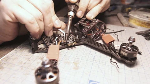 The guy solders the FPV chips of the drone. Front frame view Video stock 139550461