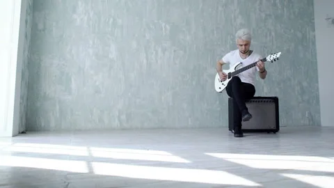 Guy on the speaker playing the guitar Stock Footage 103997148