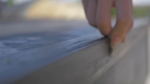 Guy spends the sandpaper on the iron railing Stock Footage 81809924