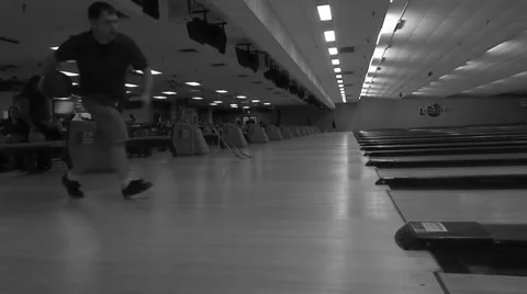 Guy spinning bowling ball down alley Stock Footage 45354721