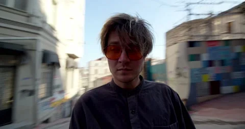 The guy spins around in the middle of town. Point of view. Body mount camera. A Stock Footage 239363787