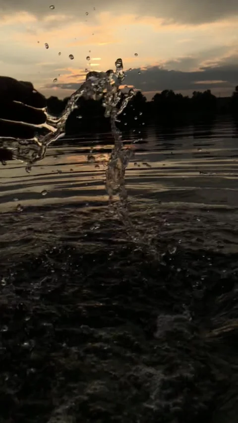 The guy splashes water with his hand on the river bank Stock Footage 161558102