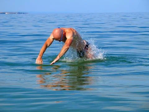 The guy splashing in the sea. Stock Photos