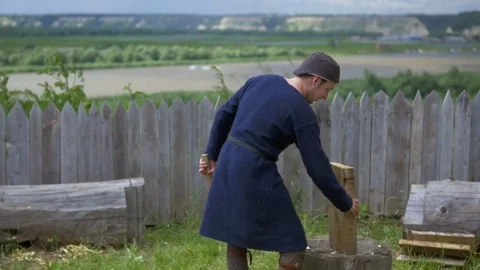 Guy splits the wood and his blade flies off the handle Stock Footage 82409489