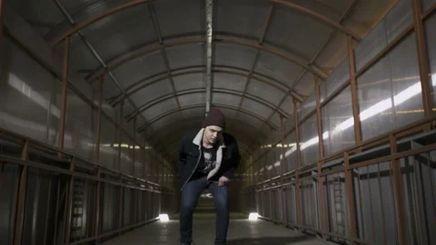 Guy squats and looks at the camera Stock Footage 80516465