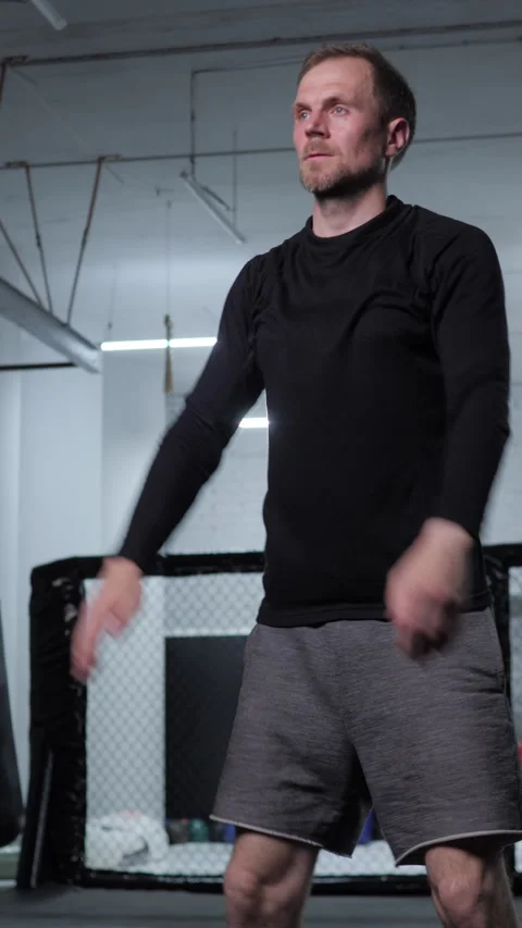 Guy squats in gym. medium shot. vertical video Stock Footage 313360543