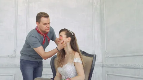 Guy squeals makes makeup to girl. Stock Footage 90273929