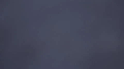 A guy is standing and looking at his watch. A guy in a white jacket Stock Footage 130743240
