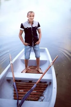 Guy standing in the boat Stock Photos