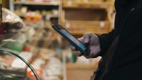 The guy is standing at the cash register in the store Stock Footage 153230001