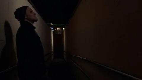 Guy is standing in the dark corridor Stock Footage 80518043