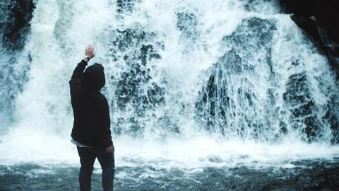 Guy Standing in Front of Waterfall Stock Photos