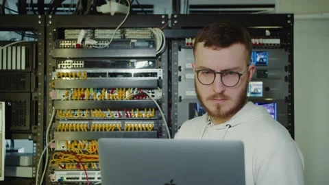 The guy is standing with a laptop in the background electrical panel Stock Footage 194163123