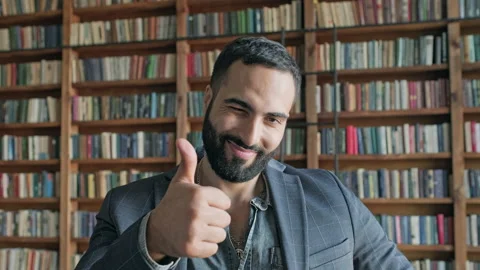 Guy Is Standing In The Library. He Points With Hand Gesture That All Is Well And Stock Footage 140222397