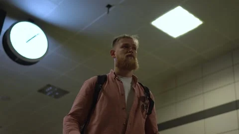The guy is standing in the lobby of the subway. bottom view Stock Footage 246296632