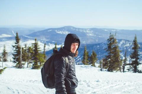 The guy is standing in the mountains in winter Stock Photos