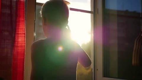 The guy standing near the window and waved his hand. Sunset 動画素材 80125655