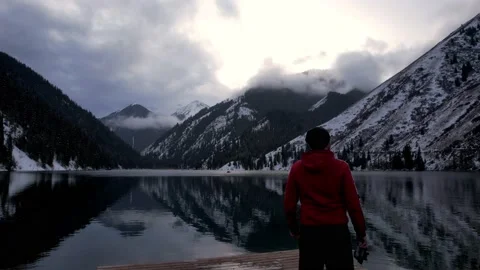The guy standing on the pier admires mountain lake Stock-Footage 226329911