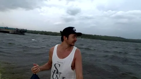 Guy standing on the shore storm wind selfie Stock Footage 161258312