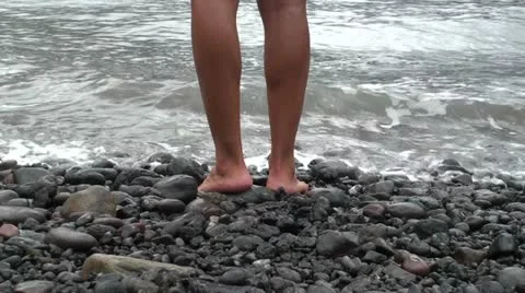 A guy standing on a volcanic stone beach Stock Footage 12701313