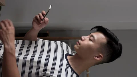 Guy standing by the window in casual wear Video stock 227095556