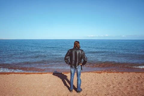 The guy stands on the beach Stock Photos