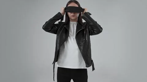 Guy stands with a black blindfold on his eyes and then takes it off. Stock Footage 287915341