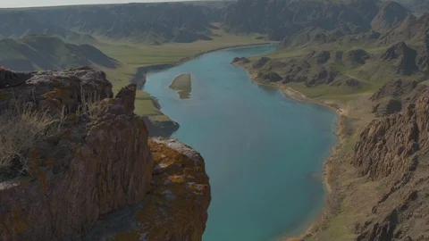 A guy stands on the edge of a cliff Stock Footage 130109714