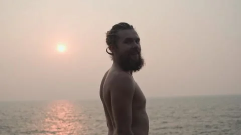 The guy stands with his back to the camera after he turns and smiles. Video stock 234020107