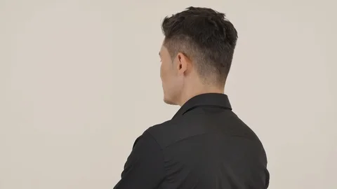 Guy Stands with his Back, then Turns to the Camera Stock Footage 87975192